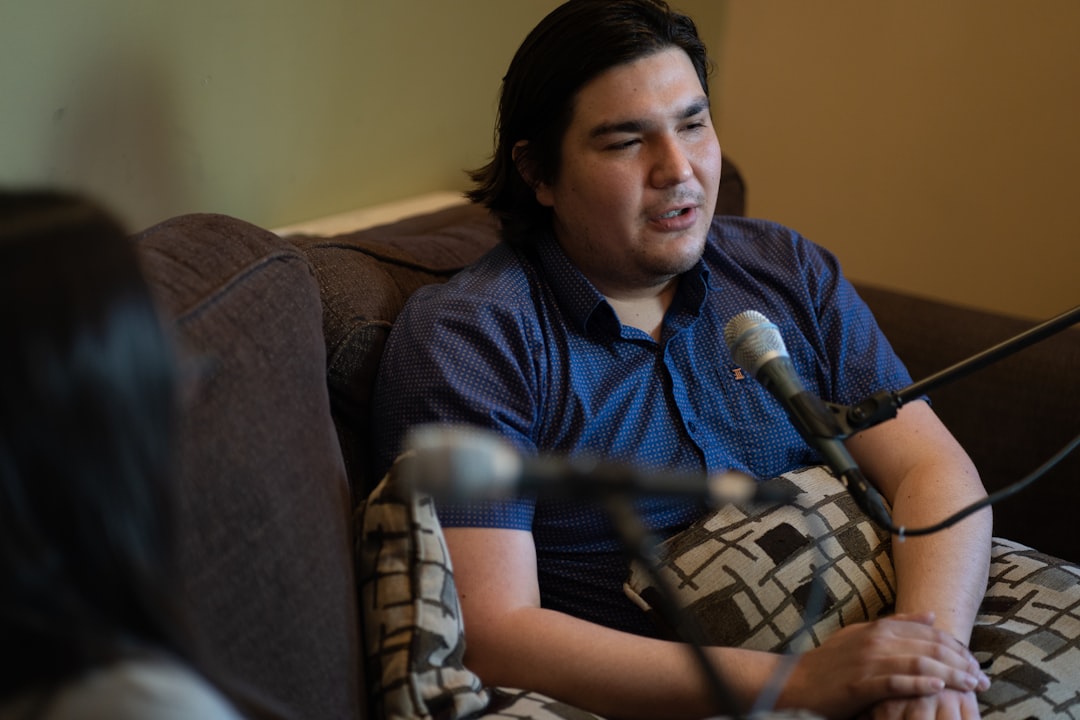 woman-in-black-and-white-crew-neck-t-shirt-sitting-on-brown-sofa-lw5bm-gf9kq